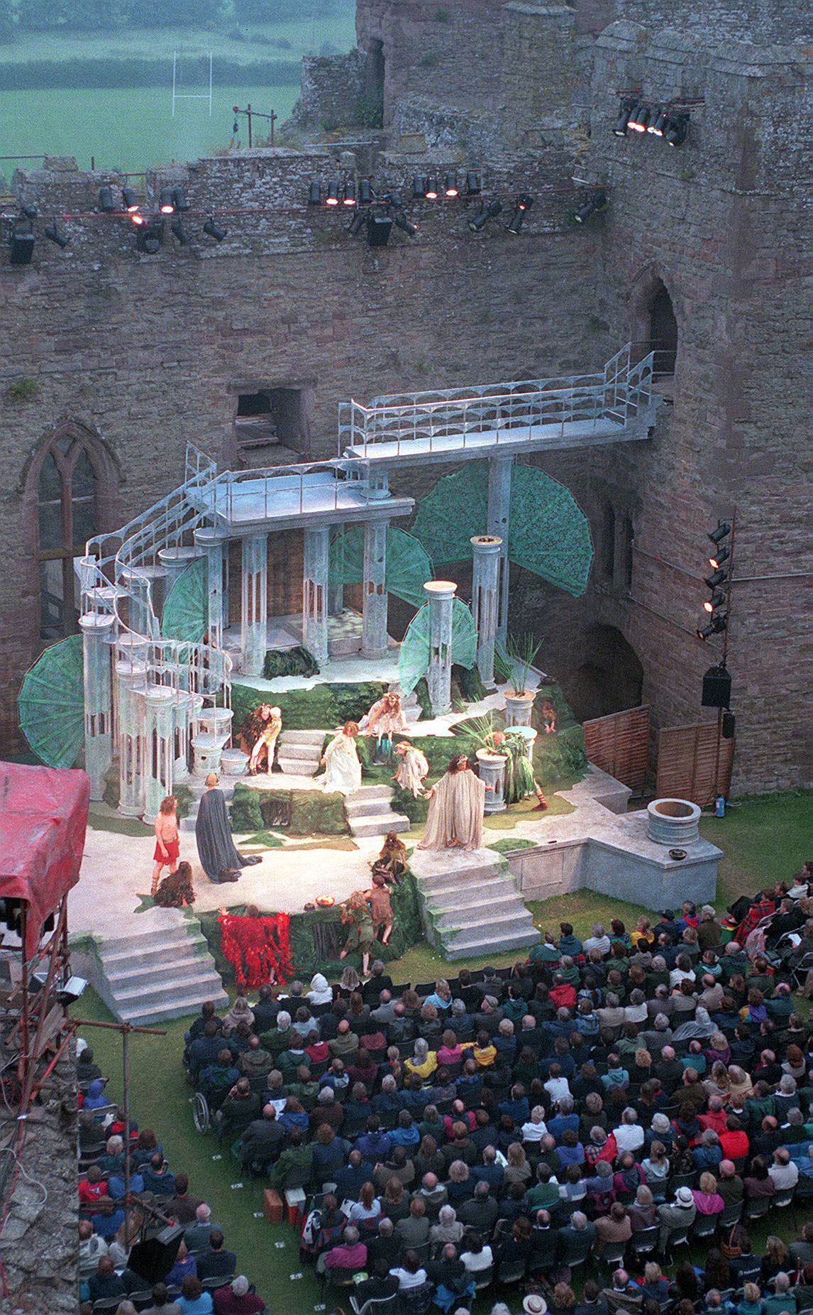 a crown watches a troop of actors perform