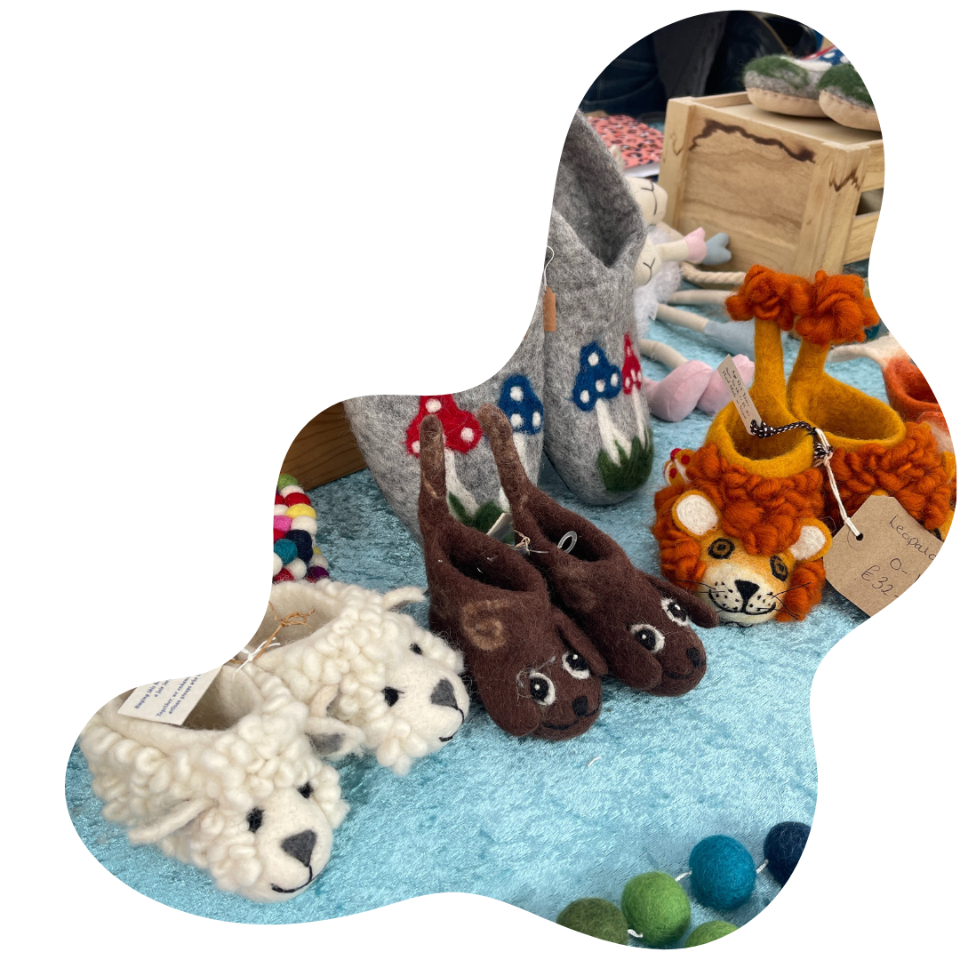 Children's animal slippers, including a sheep, dog and lion.
