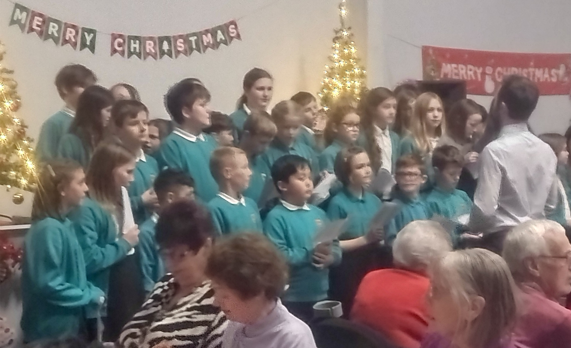 Local residents enjoying a performance from School Children