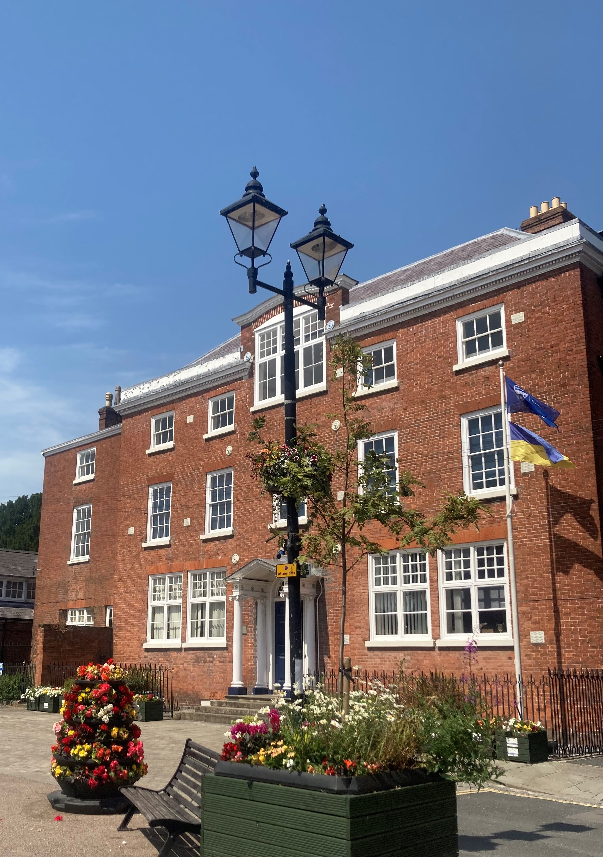 the red bricked college with an uninterupted blue sky in the background