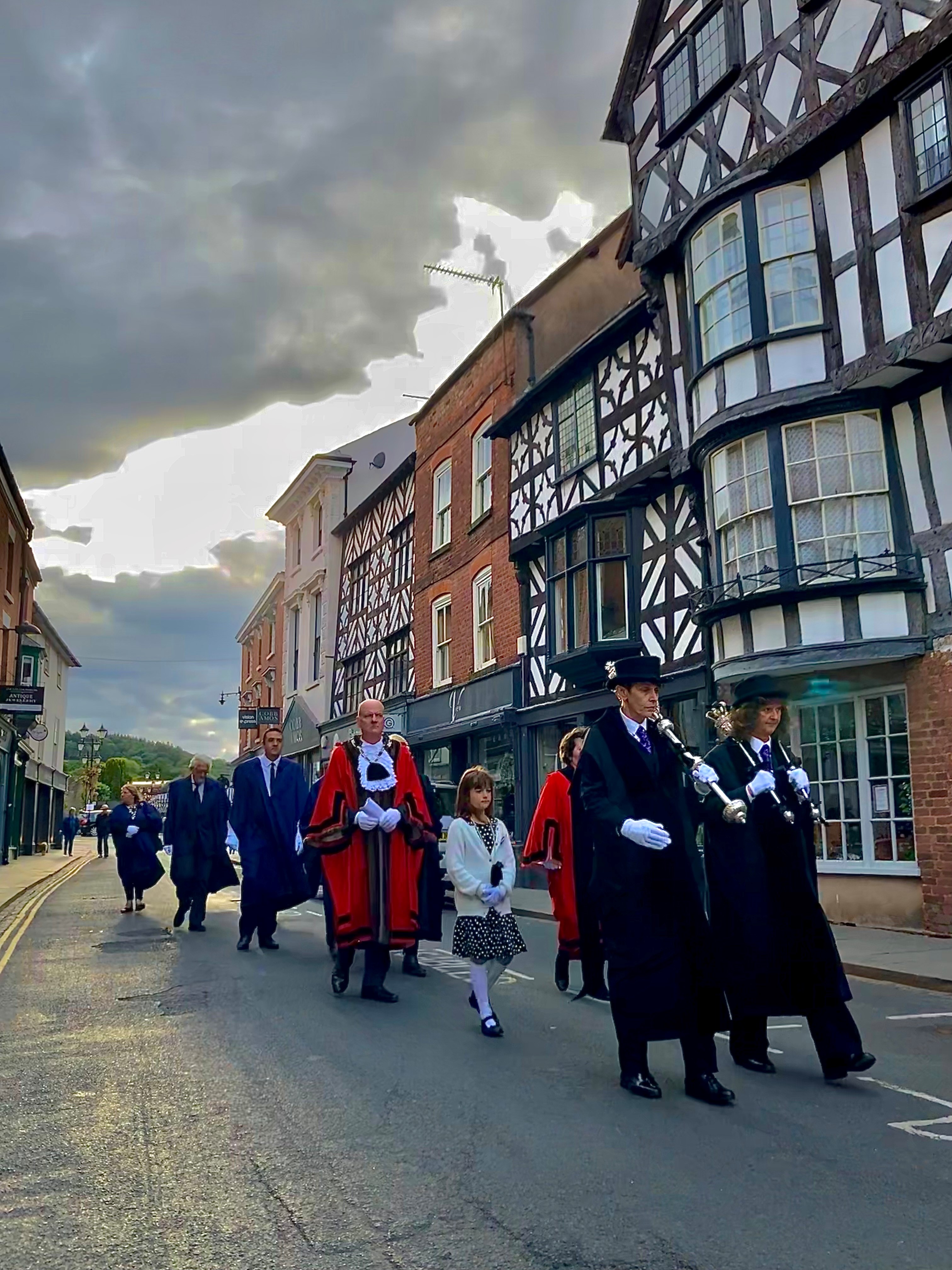 a procession Led by Two mace bearers walk towards the Church