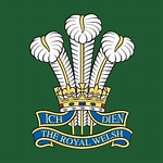 The Royal welsh writen nscript under their motto 'Ich Dien' and three goose feathers 