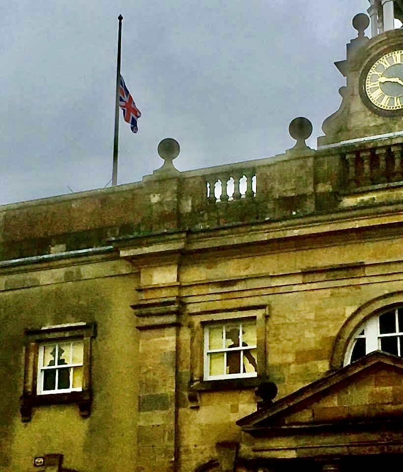 The union flag flies at half mast over the buttercross